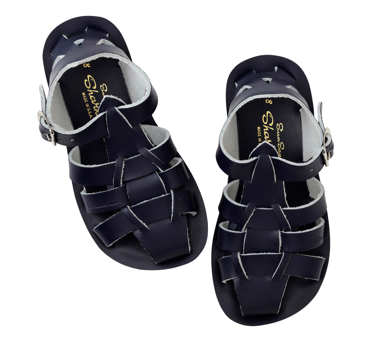 A unisex shark style sandal by Salt Water Sandals in navy with buckle fastening around the ankle. Closed Toe and caged back with woven detail across the instep. Pair view.