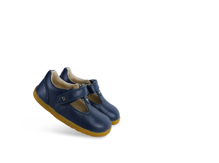 A unisex first shoe by Bobux, style Louise, a velcro T-bar in navy. Angled pair.