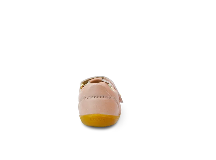 A girls first shoe by Bobux, style Louise, a velcro T-bar in dusky pink pearl. View of the back.