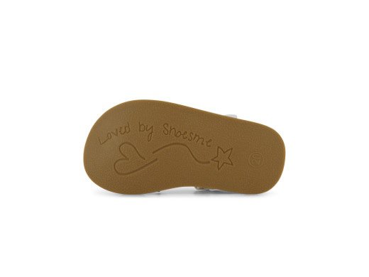 A girls open toe closed back sandal by Shoesme, style CS23S007-C, in white and rose gold with rose gold heart detail to right side and flower detail to one of the straps. Velcro fastening. Sole view.