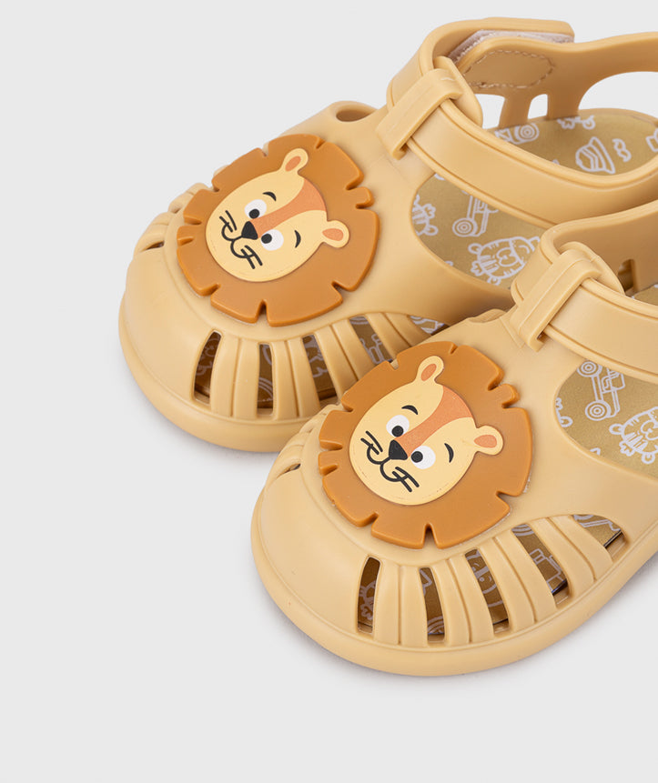 A unisex jelly shoe by Igor, style Tobby Leon in Dijon with velcro strap and lion design on front. Zoomed view of lion design