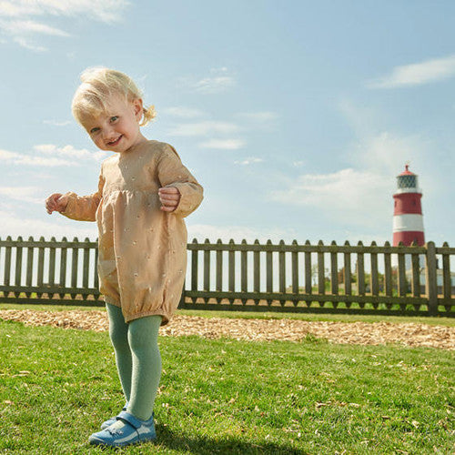 A child wearing a pair of girls Mary Jane shoes by Start Rite, style Fairy Tale, in pale blue patent with velcro fastening.