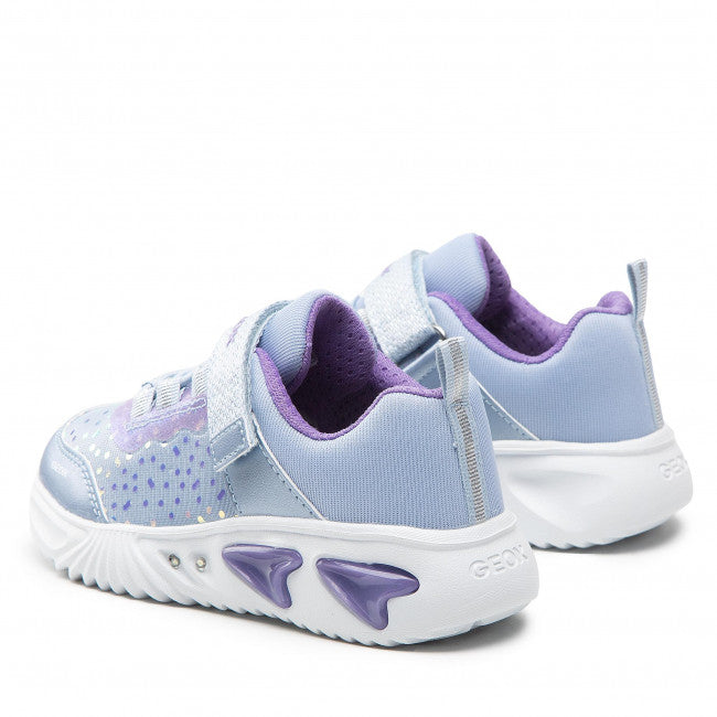 A girls light up trainer by Geox, style J Assister G, in sky blue with violet iridescent print. Velcro/ bungge lace fastening and a light up sole. Side view of a pair.