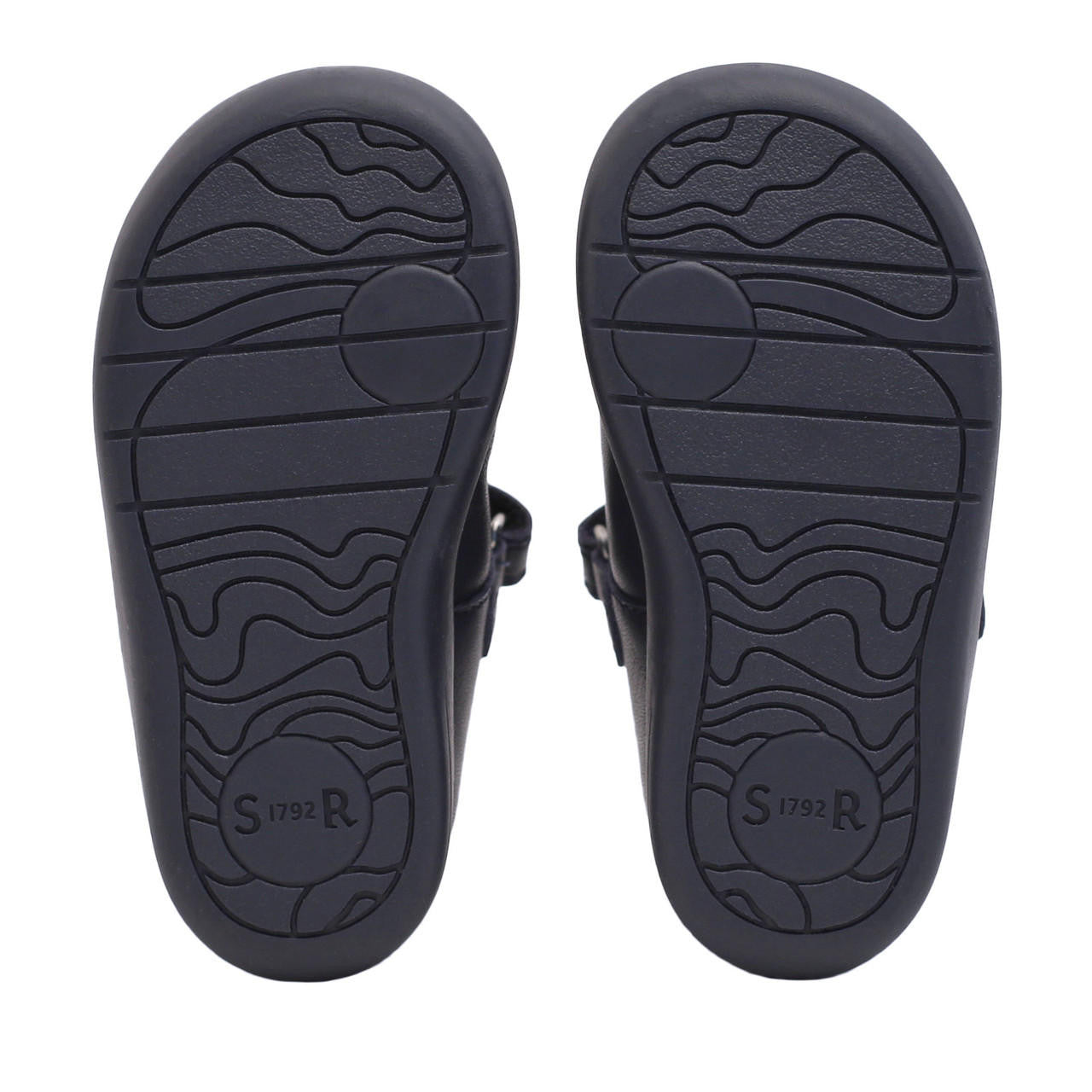 A pair of unisex T-Bar shoes by Start-Rite, style Jigsaw, in navy leather with punch out detail.  View of soles.