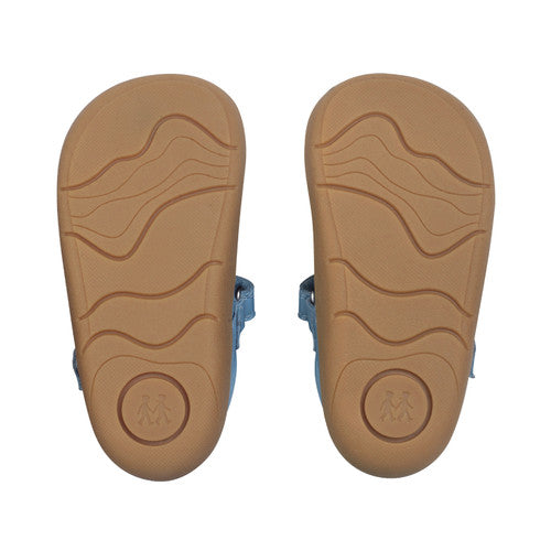 A girls T-Bar first shoe by Start-rite, style Floret, in pearlised taupe leather with flower detail and toe bumper. Velcro Fastening. View of soles of a pair.