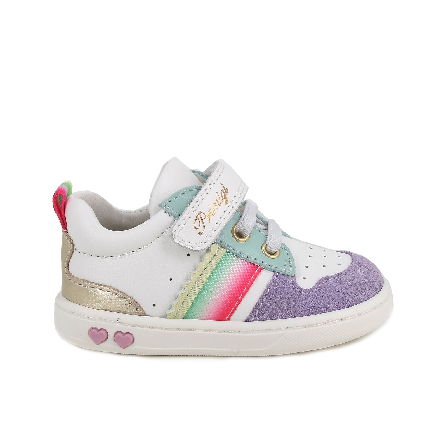 A girls casual trainer by Primigi, style Baby Like in white/iris with elastic laces and velcro strap. Rainbow stripe detail onside purple toe bumper pattern, and metallic design on heel. Two small pink love hearts on white sole. Right side view