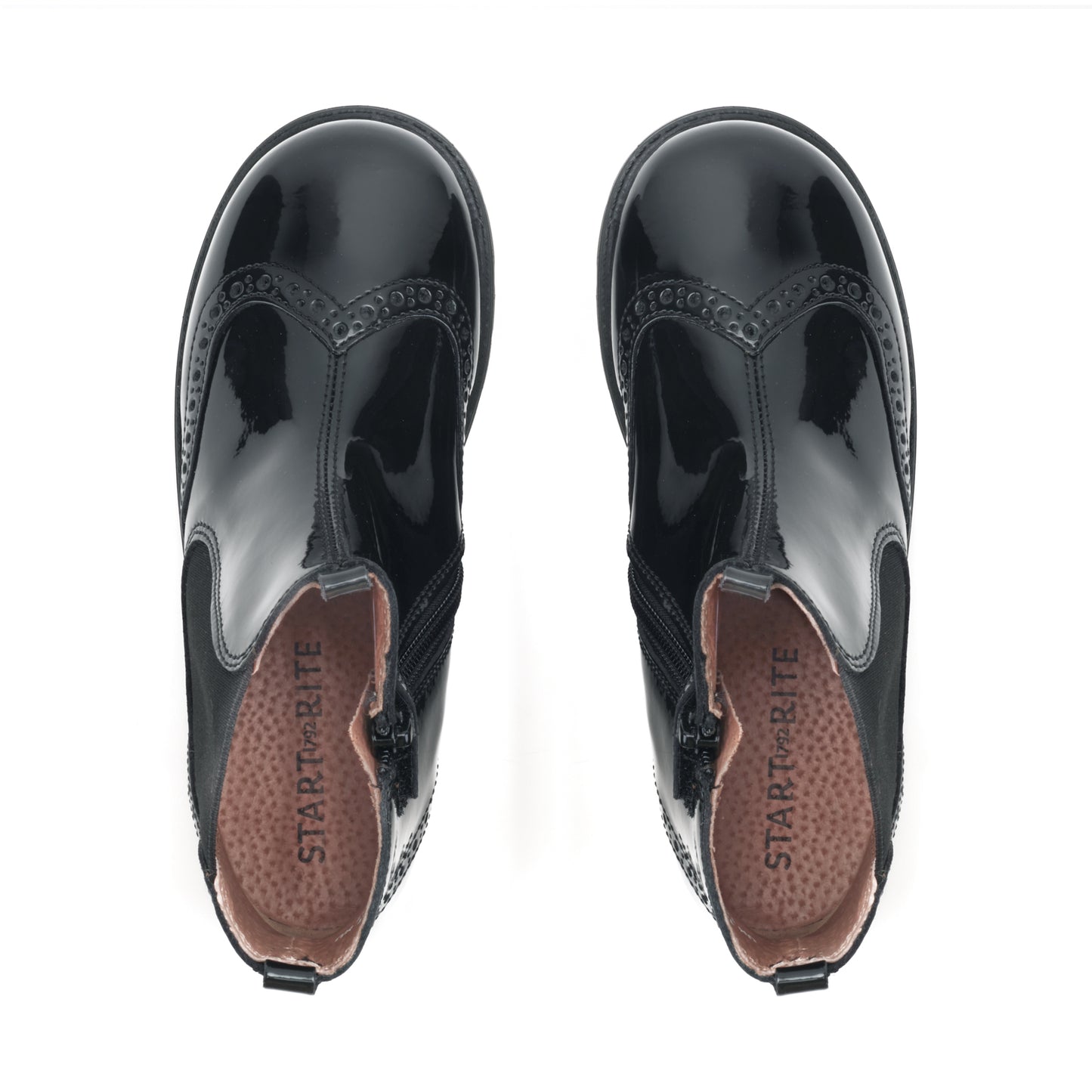 A girls Chelsea boot by Start-Rite, style Chelsea in black patent leather with brogue detail, elastic side panel and zip fastening. View of pair from above.