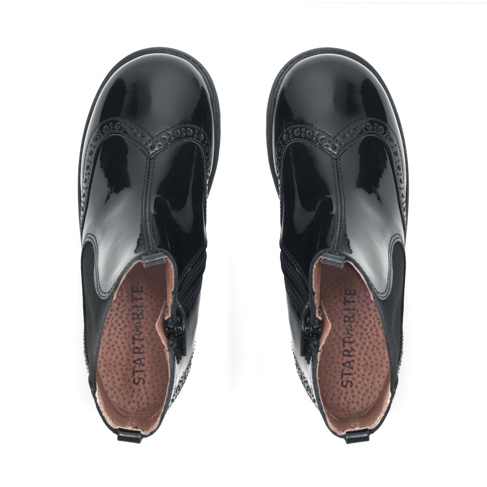 A girls Chelsea boot by Start-Rite, style Chelsea in black patent leather with brogue detail, elastic side panel and zip fastening. View of pair from above.