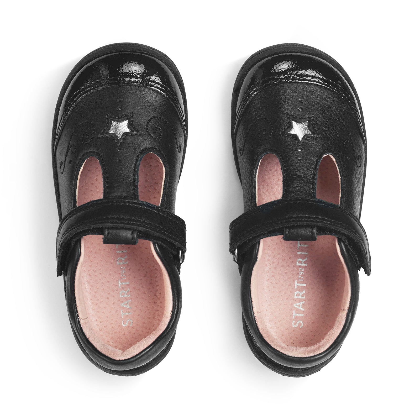 A girls T-Bar school shoe by Start-Rite, style Dazzle, in black leather with patent trim and star detail. Velcro fastening. View of pair.