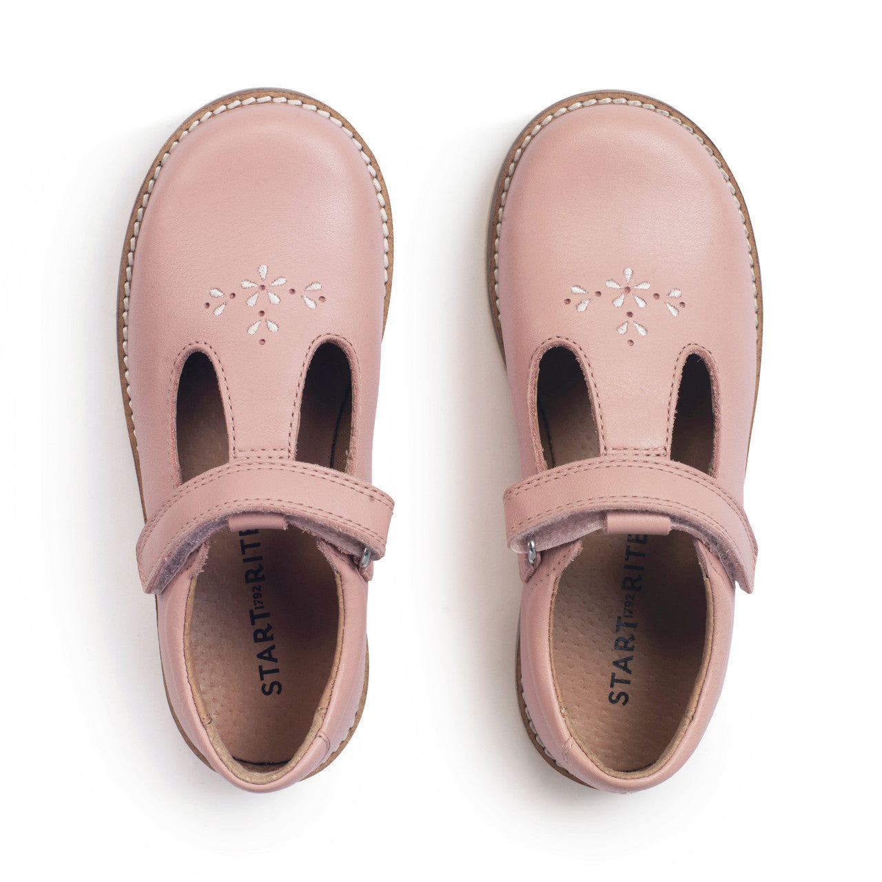 A girls T-Bar shoe by Start-Rite, style Luxe, with pink embroidery in pale pink leather with velcro fastening. View of pair from above.