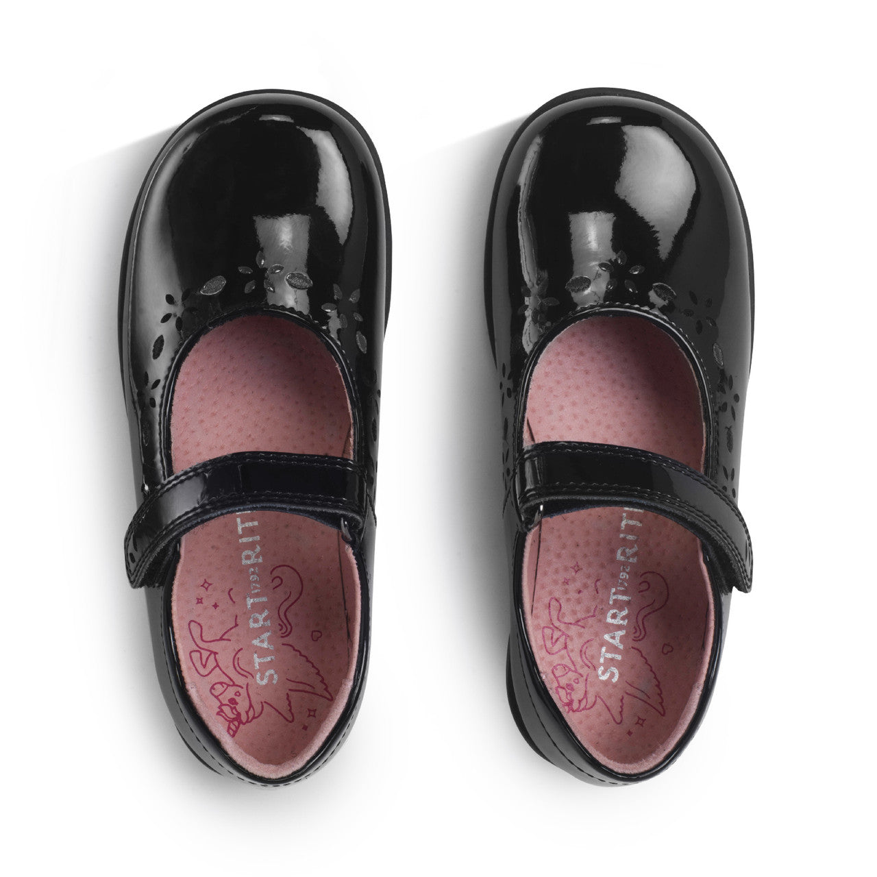 A girls Mary Jane school shoe by Start Rite, style Emily, in black patent with punch out flower detail and velcro fastening. View of pair from above.