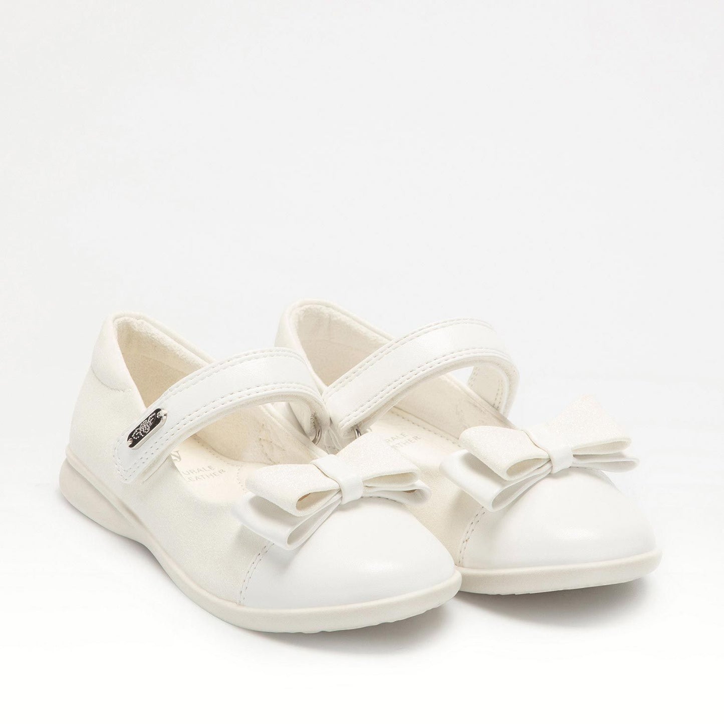 A pair of girls Mary Jane shoes by Lelli Kelly, style LKBA1710 Adele, in white glitter leather with bow detail and velcro fastening. Angled view of right side.