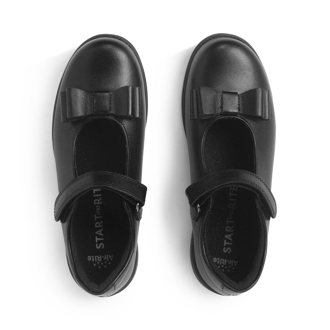 A girls T-Bar school shoe by Start-Rite, style Bella in black with bow detail and velcro fastening. View of pair from above.