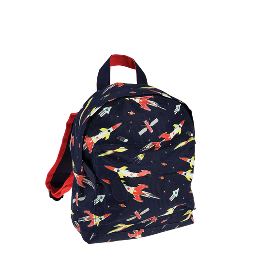 A childs backpack by Rex London, style Space Age, in blue with multi rocket print, two compartments and zip fastenings. Angled view. 