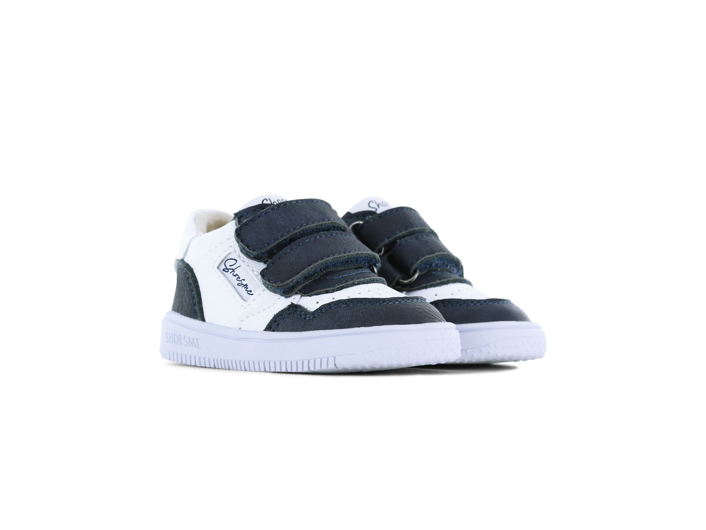 A boys mid top trainer by Shoesme, style BN25S006-B in white and navy, double velcro straps. Front angled view of a pair.