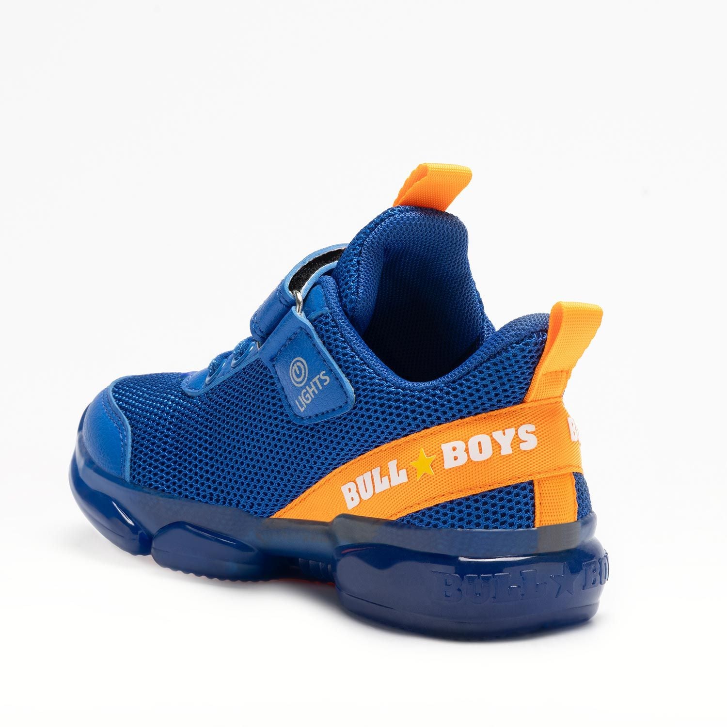 A boys trainer by Bull Boys, style DNAL2130 T-Rex, in blue with green dinosaur in 3D and flashing sole. Velcro and elastic faux lace fastening. Angled view.