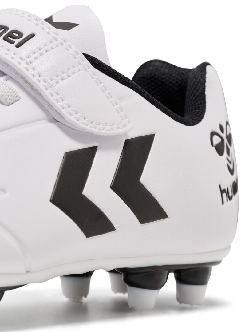 A firm ground football boot by Hummel, style Top Star F.G JR 216568-9001, in white with elastic lace and velcro fastening. Right side view. Close up of motif.