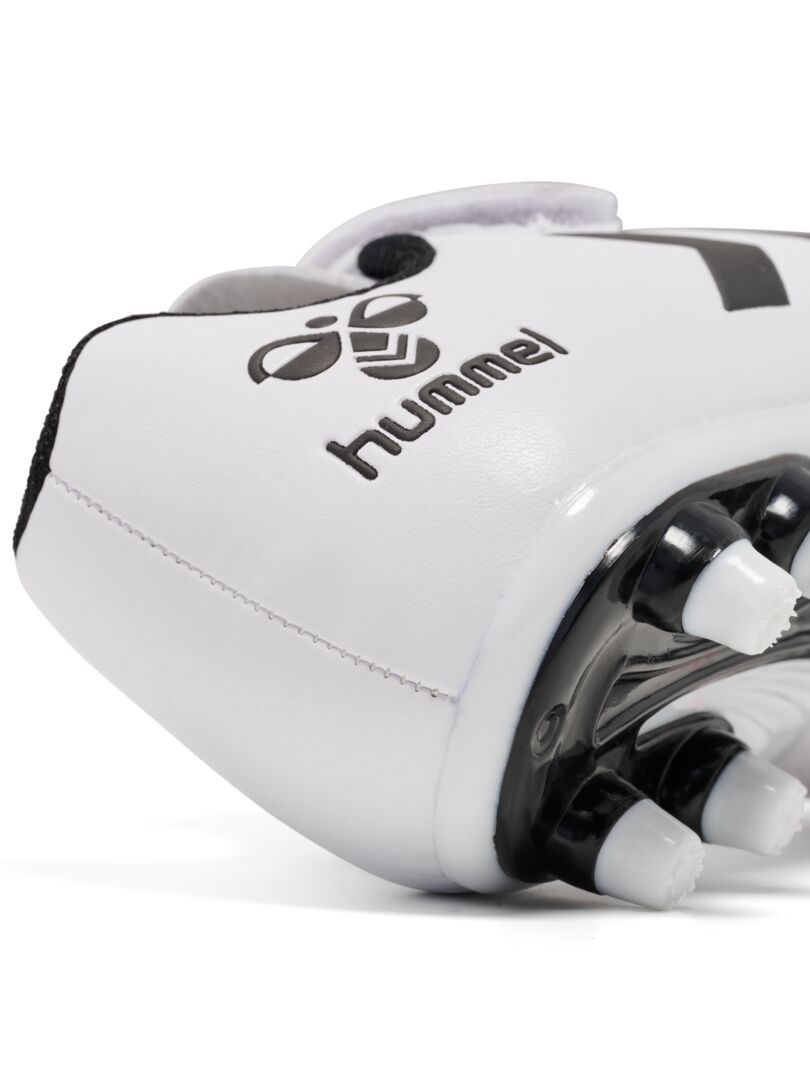 A firm ground football boot by Hummel, style Top Star F.G JR 216568-9001, in white with elastic lace and velcro fastening. Right side view. Angled close up of heel.