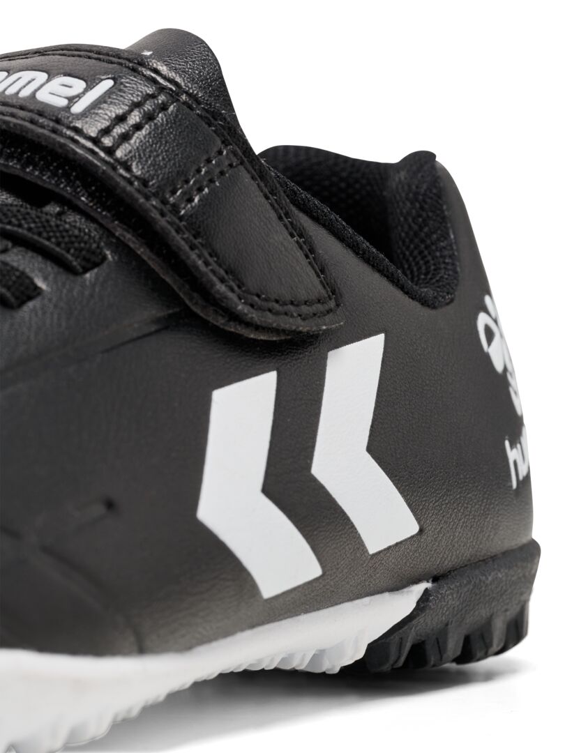 A Astro Turf Football boot by Hummel, style 228343-2042 Top Star Turf JR in black and white with elastic lace and velcro fastening. Close up view.