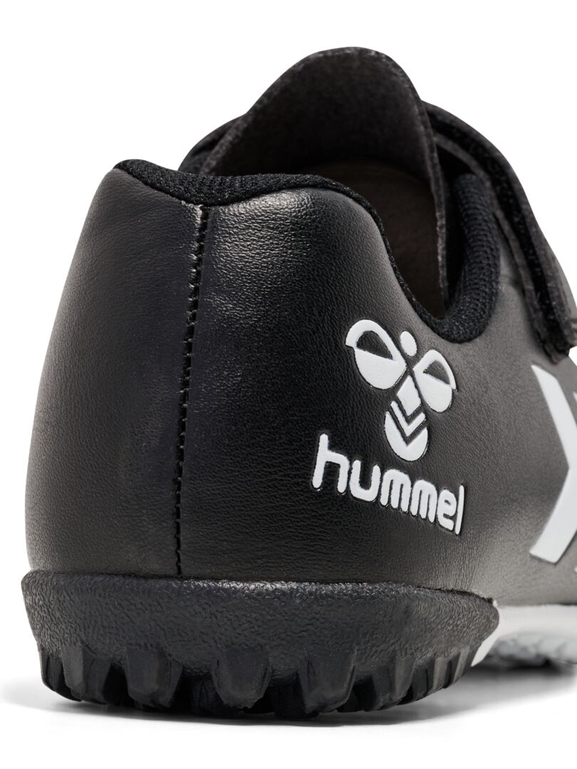 A Astro Turf Football boot by Hummel, style 228343-2042 Top Star Turf JR in black and white with elastic lace and velcro fastening. View of heel.