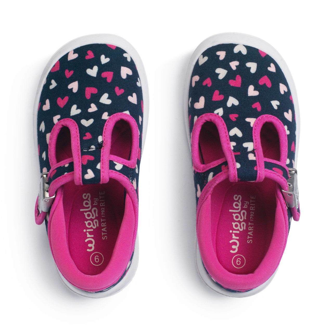 A girls shoe by Start-Rite, style Wriggles T bar, in navy with pink hearts and pink trim. Buckle fastening. View of pair from above.