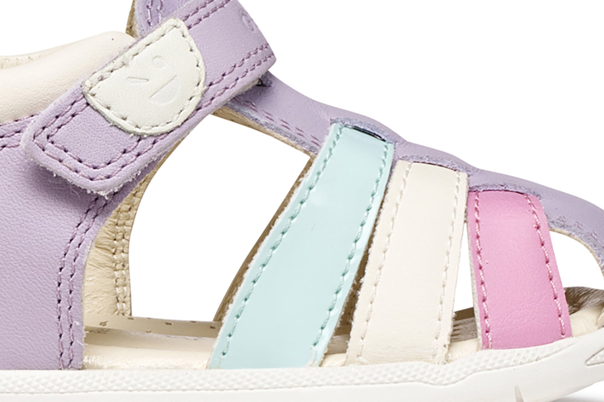 A girls sandal by Geox, style Macchia in lilac/watersea with blue white and pink on front and a velcro strap. Zoomed view of side