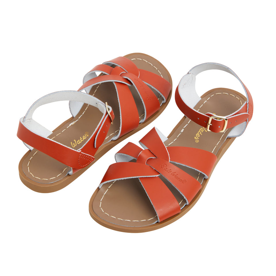 An original girls sandal by Salt Water Sandals in paprika with a single buckle fastening around the ankle. Open Toe and Sling-back with woven detail on the front. Side by Side view.