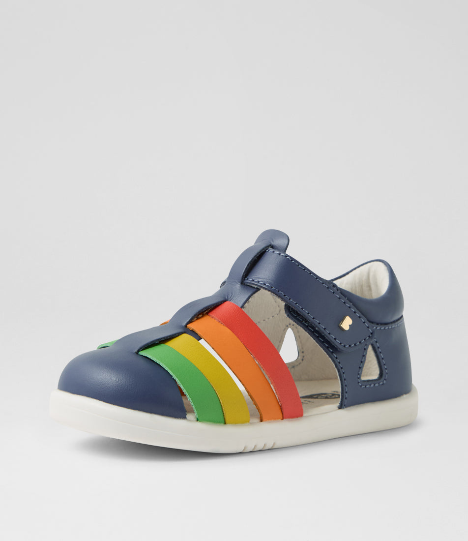 A unisex sandal by Bobux, style Tidal, in Vintage Indigo with velcro strap and rainbow coloured design. Angled front view