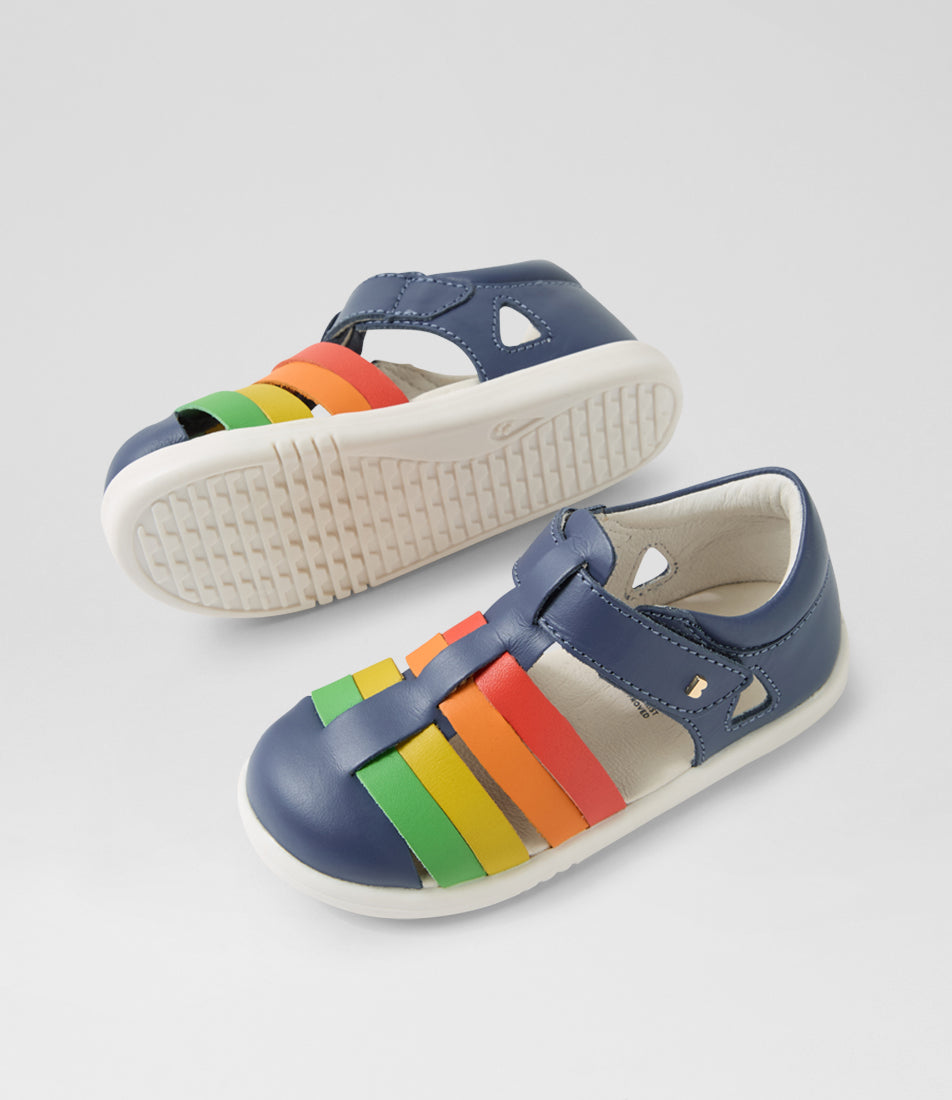 A unisex sandal by Bobux, style Tidal, in Vintage Indigo with velcro strap and rainbow coloured design. View of pair with white sole