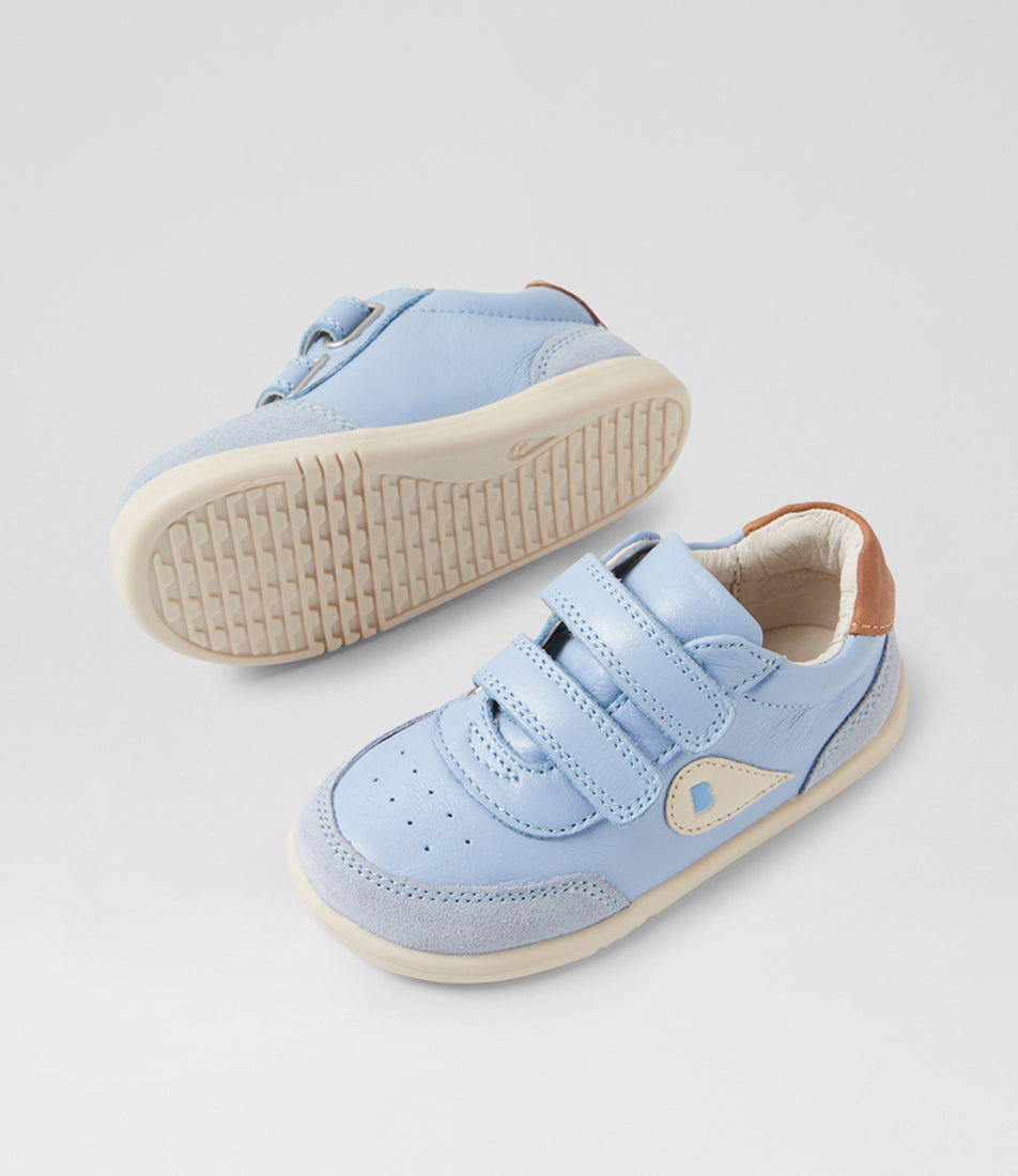 A unisex casual shoe by Bobux, style Champ (Step Up) in Skyway with two velcro stras, brown back ankle detail and white sole. View of pair with one sole showing