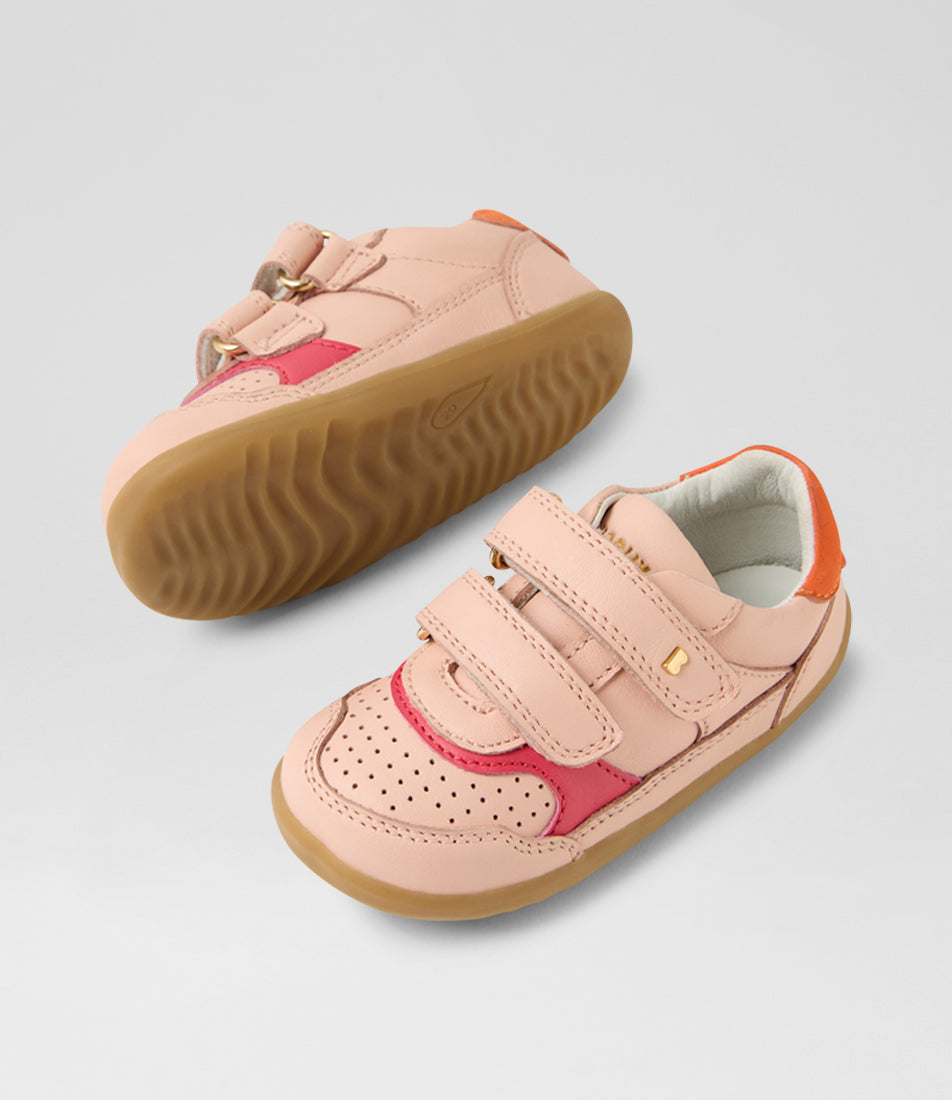A girls casual shoe by Bobux, style Hunter (Step Up) in Cameo Rose/Nasturtium with two velcro straps and light brown sole. View of pair with one sole showing