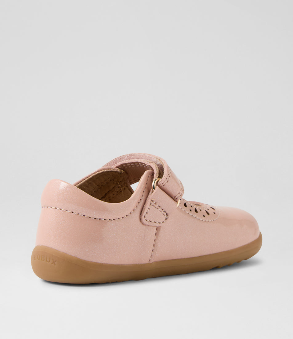 A girls casual shoe by Bobux, style Lola (Step Up) in Cameo Rose with velcro strap, cut out pattern detail and light brown sole. Angled inner left side view