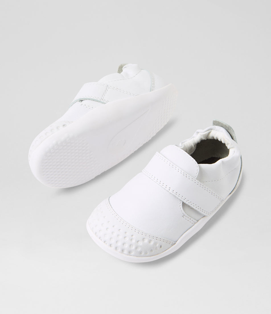 A unisex pre-walker shoe by Bobux, style Xplorer in white. With a velcro strap and front toe bumper. View of pair with white sole
