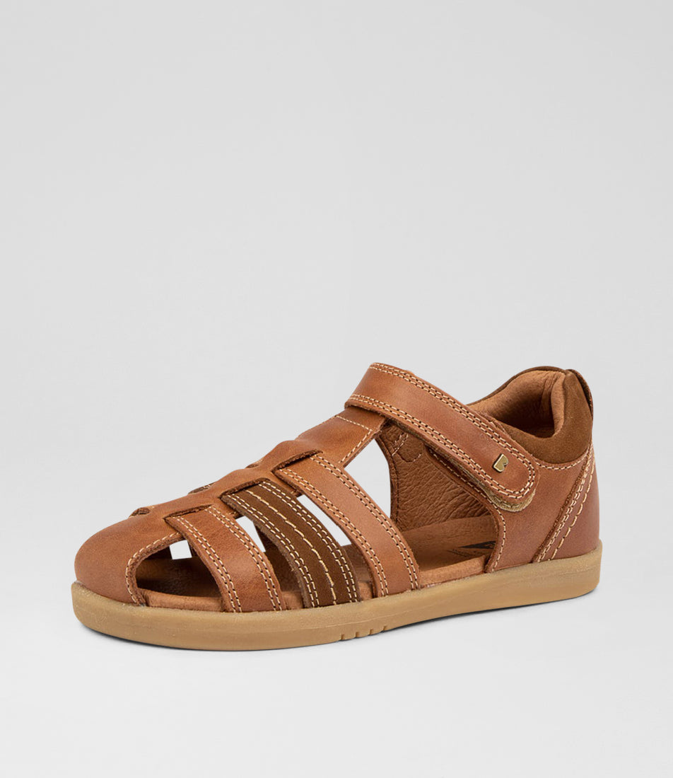 A unisex sandal by Bobux, style Roam in Caramel with velcro strap. Angled left side view