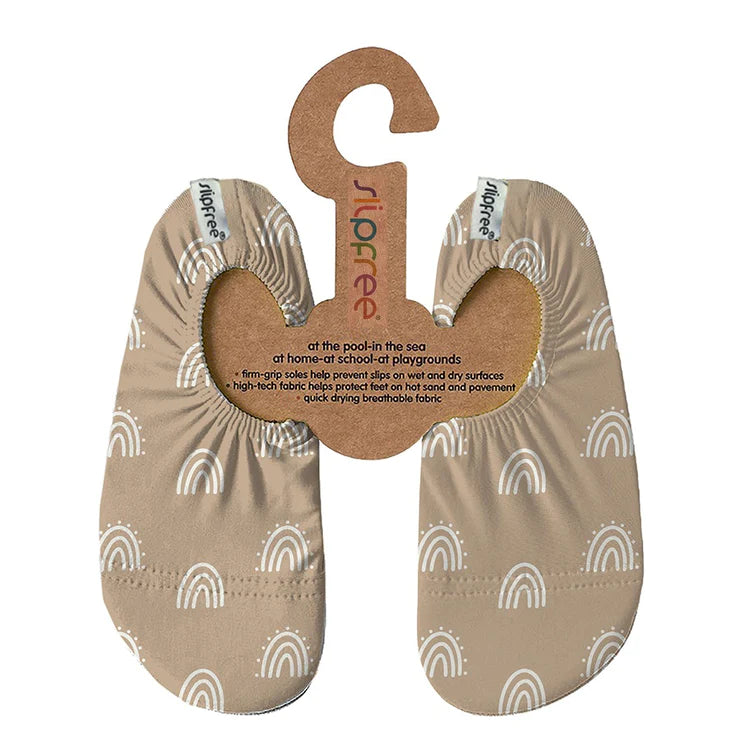 A girls non-slip shoe by Slipfree, style Caramel, in beige with white abstract print. Front view.