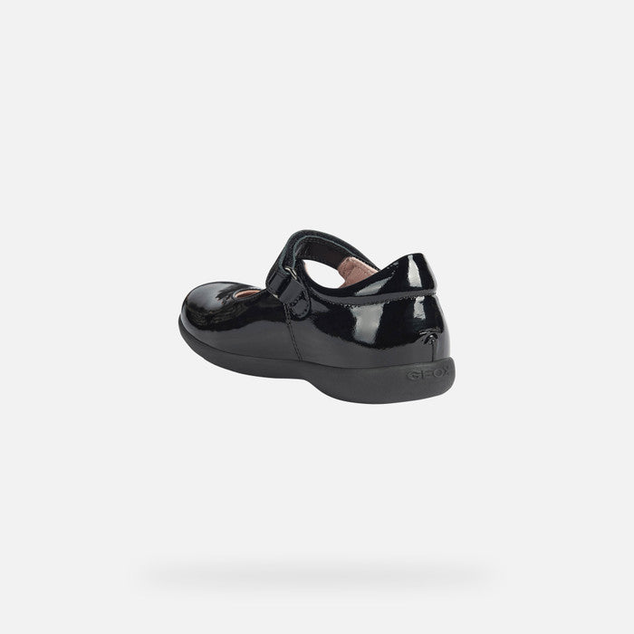 A girls Mary Jane school shoe by Geox, style Naimara, in black patent with velcro fastening. Angled view.