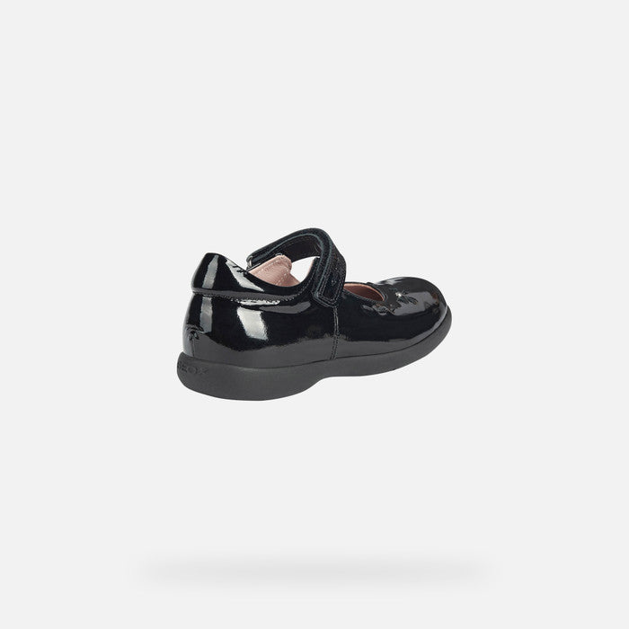 A girls Mary Jane school shoe by Geox, style Naimara, in black patent with velcro fastening. Angled view.