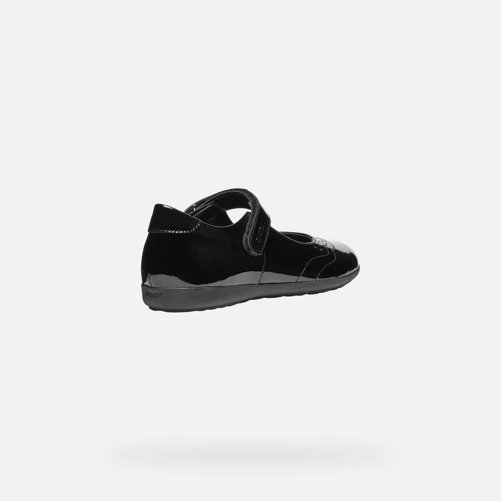 A girls Mary Jane school shoe by Geox, style J46MDG Iberide Girl, in black patent with punch hole detail and velcro fastening. Angled view right side.