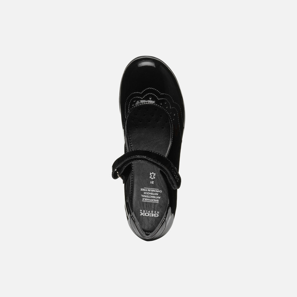 A girls Mary Jane school shoe by Geox, style J46MDG Iberide Girl, in black patent with punch hole detail and velcro fastening. View from above.