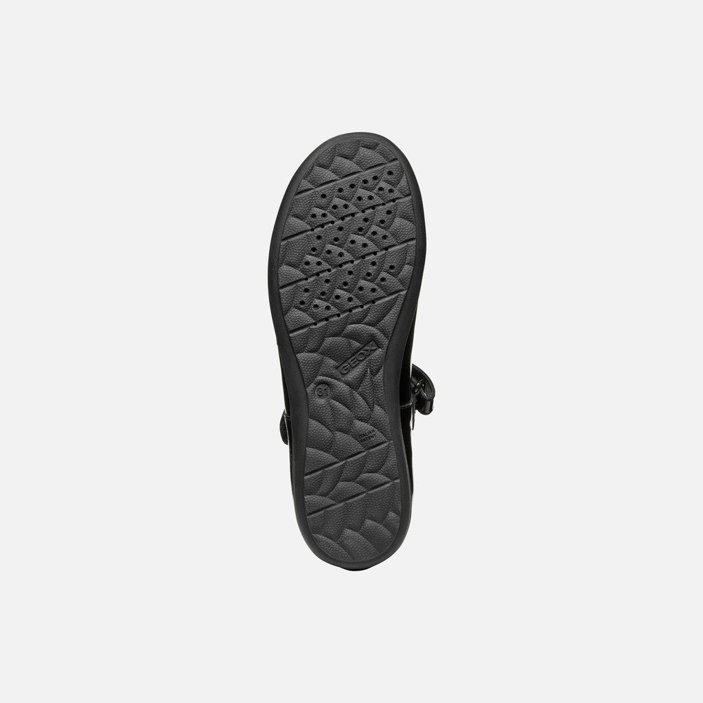 A girls Mary Jane school shoe by Geox, style J46MDG Iberide Girl, in black patent with punch hole detail and velcro fastening.  View of sole.