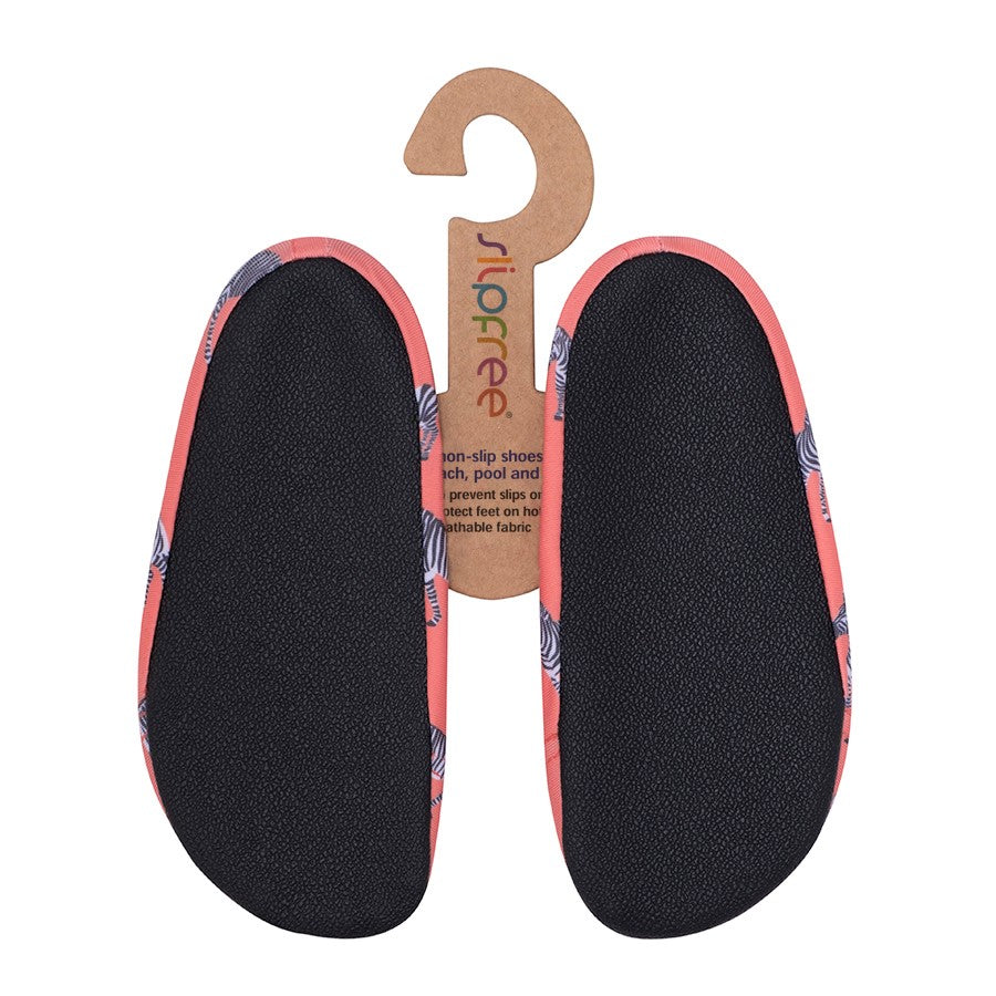 A unisex non slip swim shoe by Slipfree, style Grevy, in coral with Zebra print. View of soles.