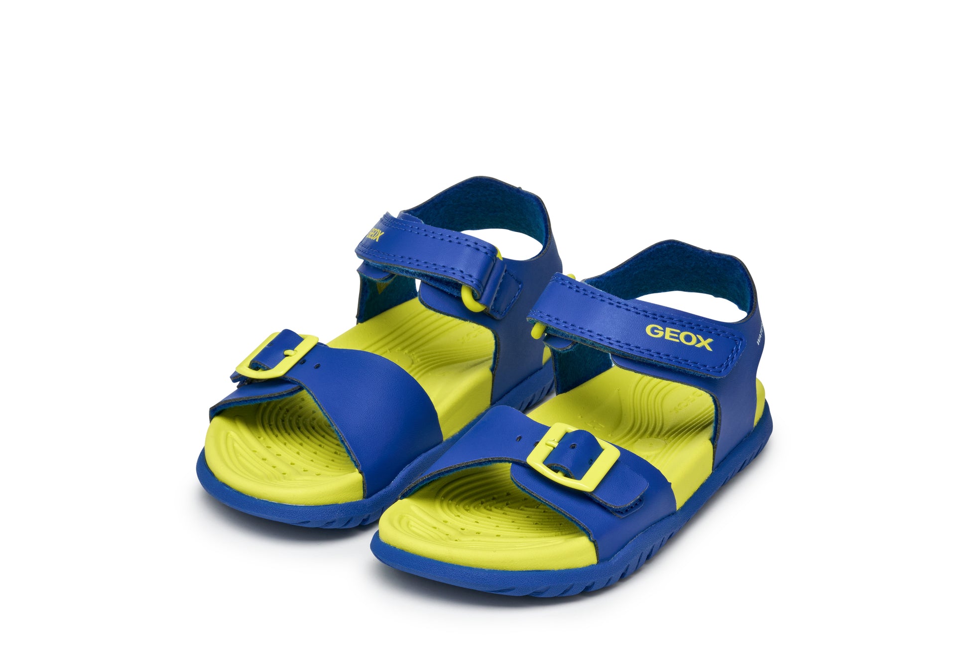 A boys sandal by Geox, style Fusbetto in royal blue and green with velcro strap and buckle at the front. Front view of pair