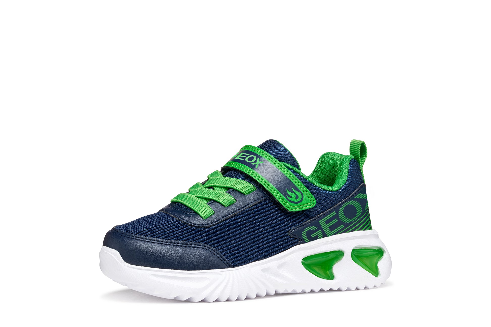 A boys trainer by Geox style Assister in navy/green with velcro strap, elastic laces, large geox logo on the side and lights in white sole. Angled right side view