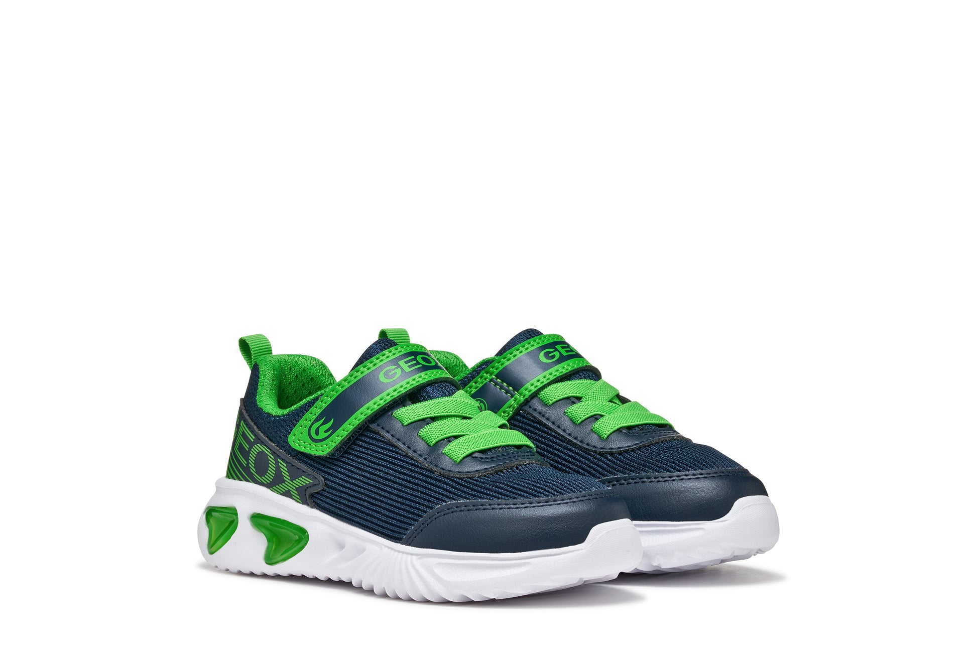 A boys trainer by Geox style Assister in navy/green with velcro strap, elastic laces, large geox logo on the side and lights in white sole. Side view of pair side by side