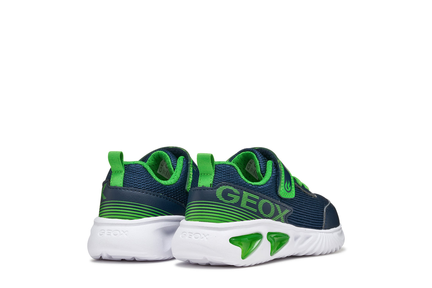 A boys trainer by Geox style Assister in navy/green with velcro strap, elastic laces, large geox logo on the side and lights in white sole. Back view of pair side by side