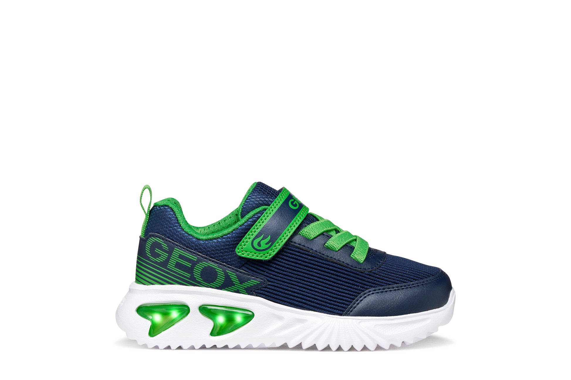 A boys trainer by Geox style Assister  in navy/green with velcro strap, elastic laces, large geox logo on the side and lights in white sole. Right side view