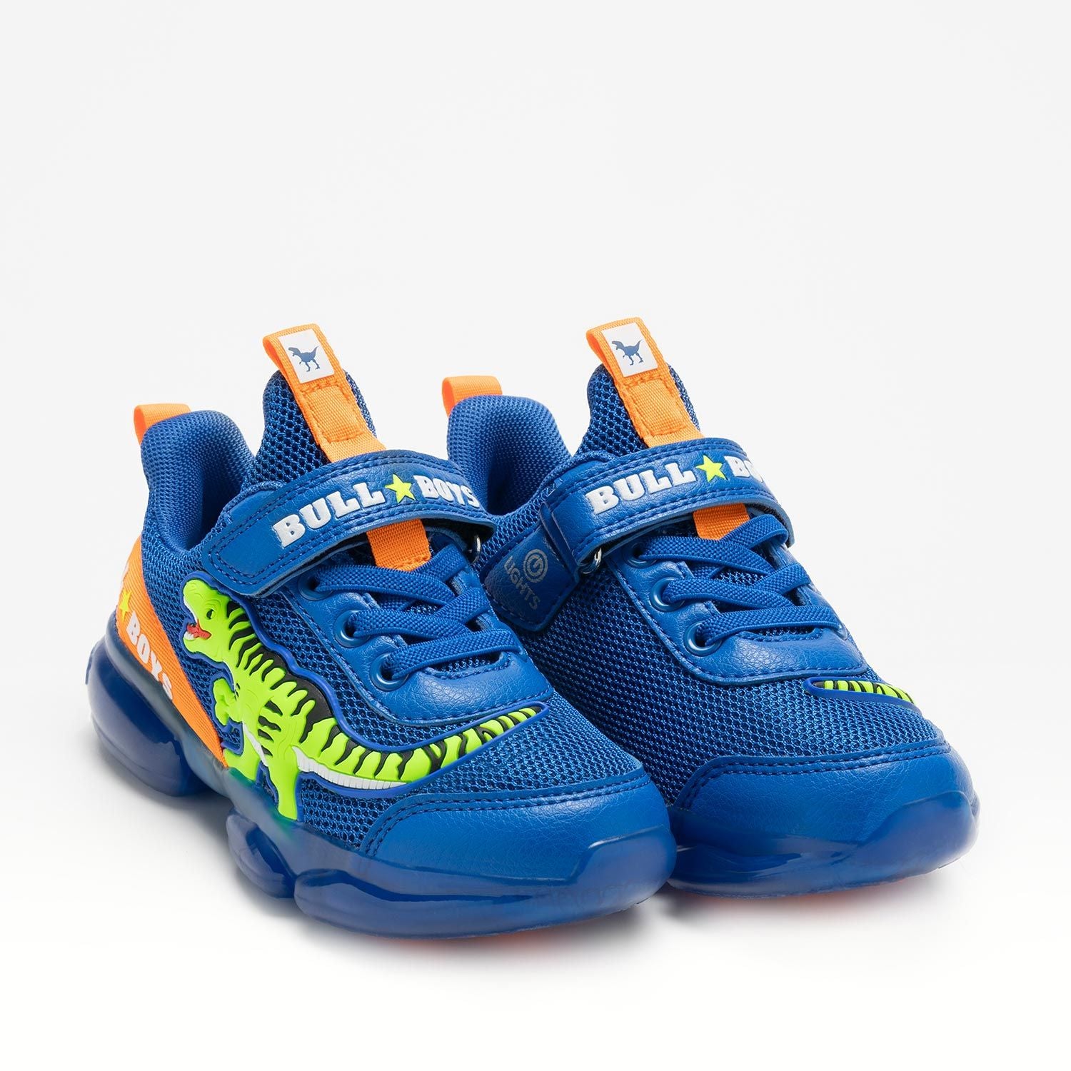 A boys trainer by Bull Boys, style DNAL2130 T-Rex, in blue with green dinosaur in 3D and flashing sole. Velcro and elastic faux lace fastening. Angled view of pair.