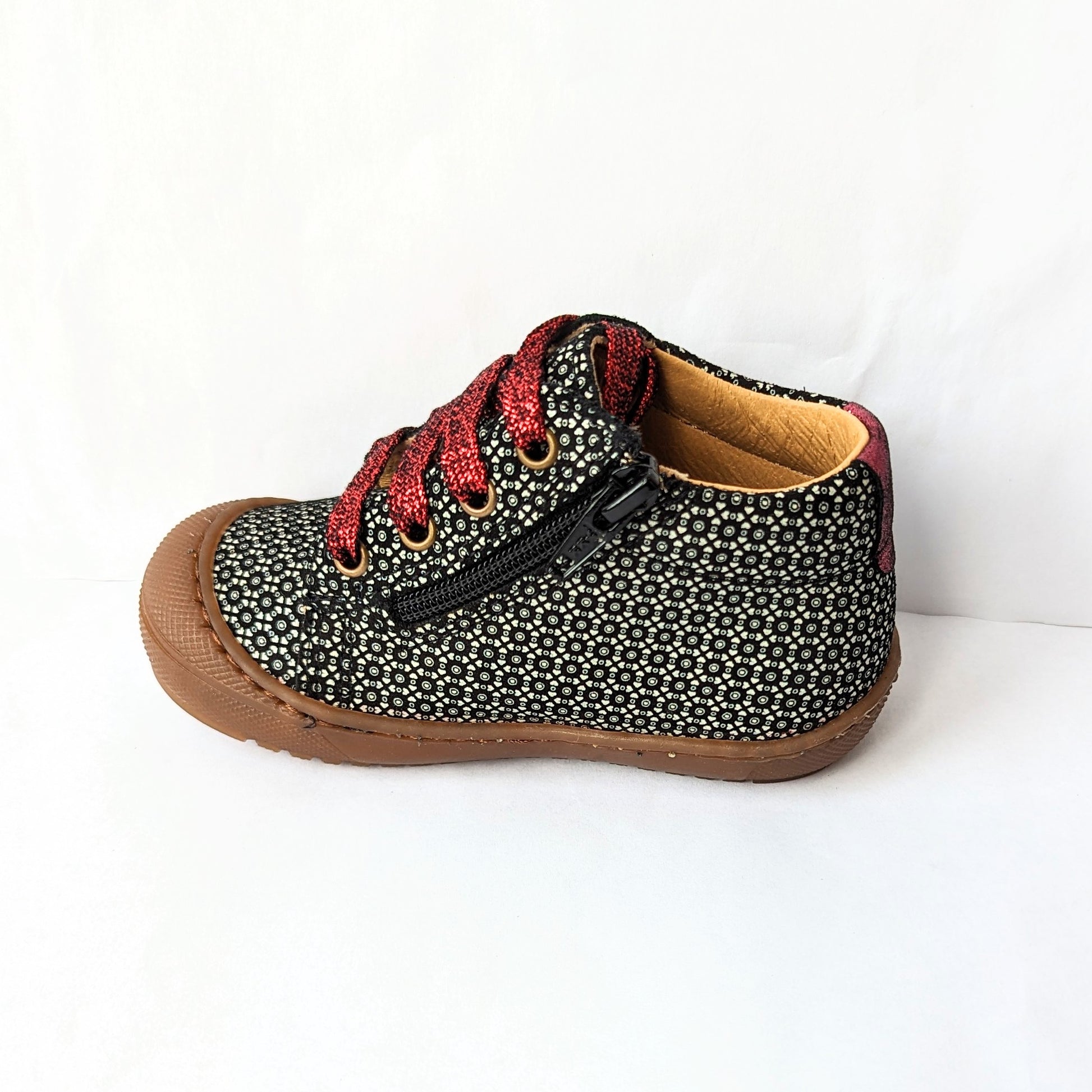 A girls ankle boot by Bopy, style Jolila, in black/silver print nubuck with toe bumper and zip/ bordeaux glitter lace fastening.   Left side view.