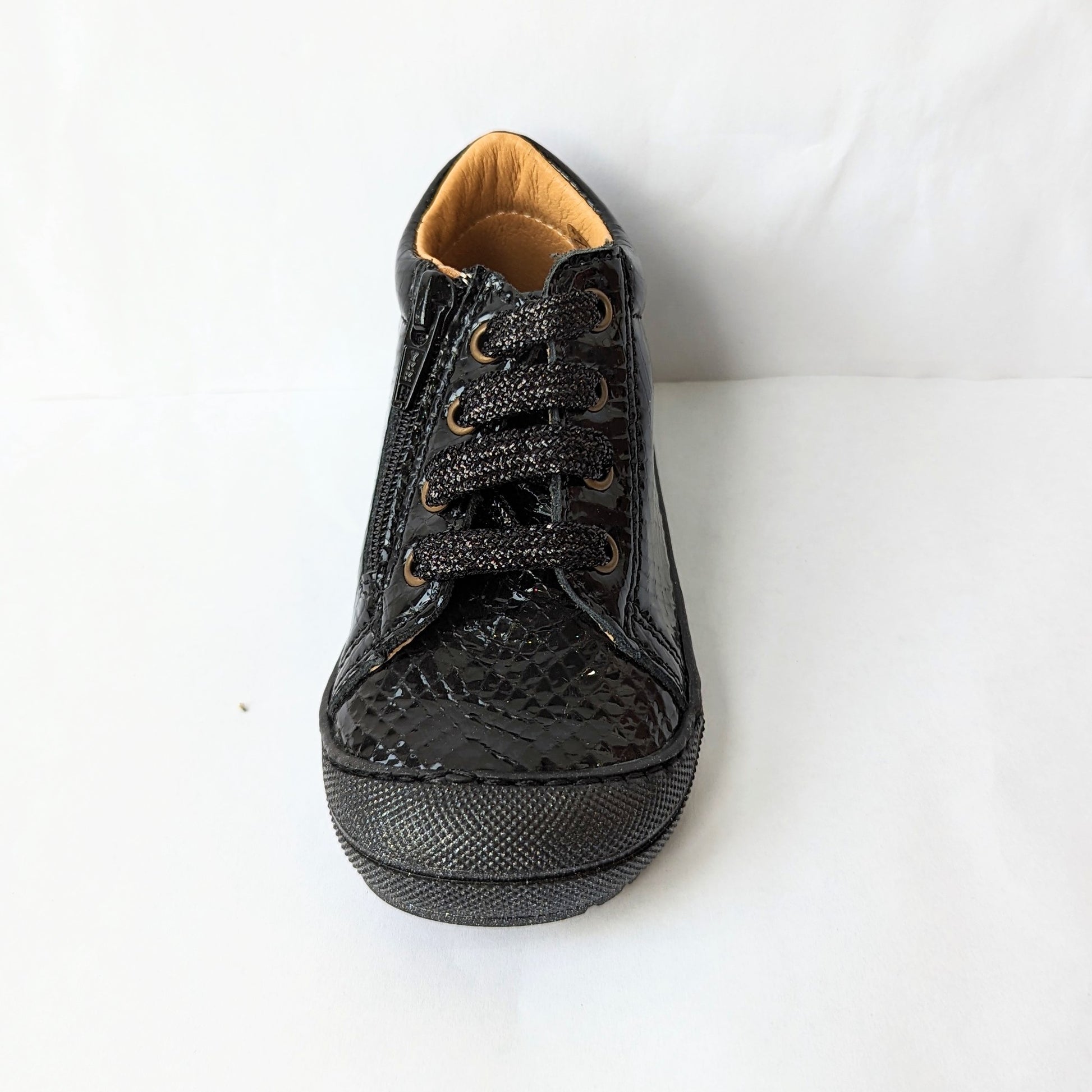 A girls ankle boot by Bopy, style Joseva, in black patent leather croc with toe bumper and zip/glitter lace fastening . Front view.