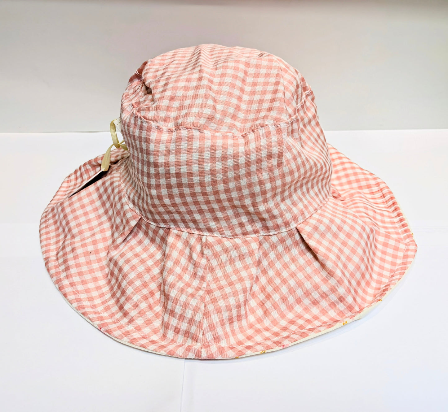 A pink and white gingham sun hat by Rockahula on a white background